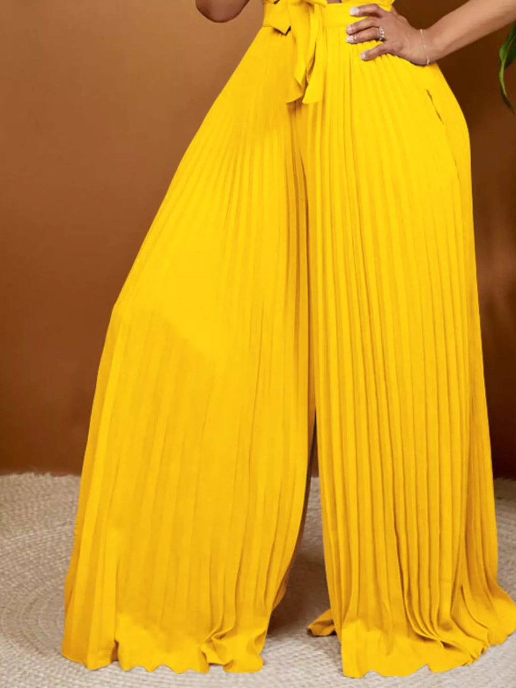 Pleated wide leg jumpsuit styled with heels