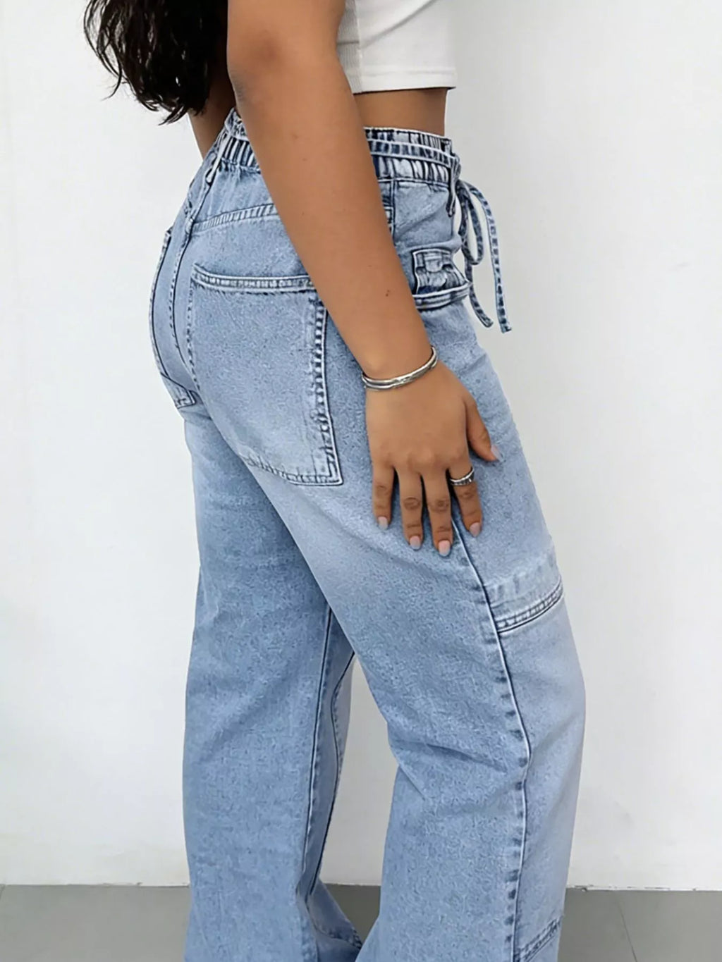 Cargo pocket detail on washed blue jeans