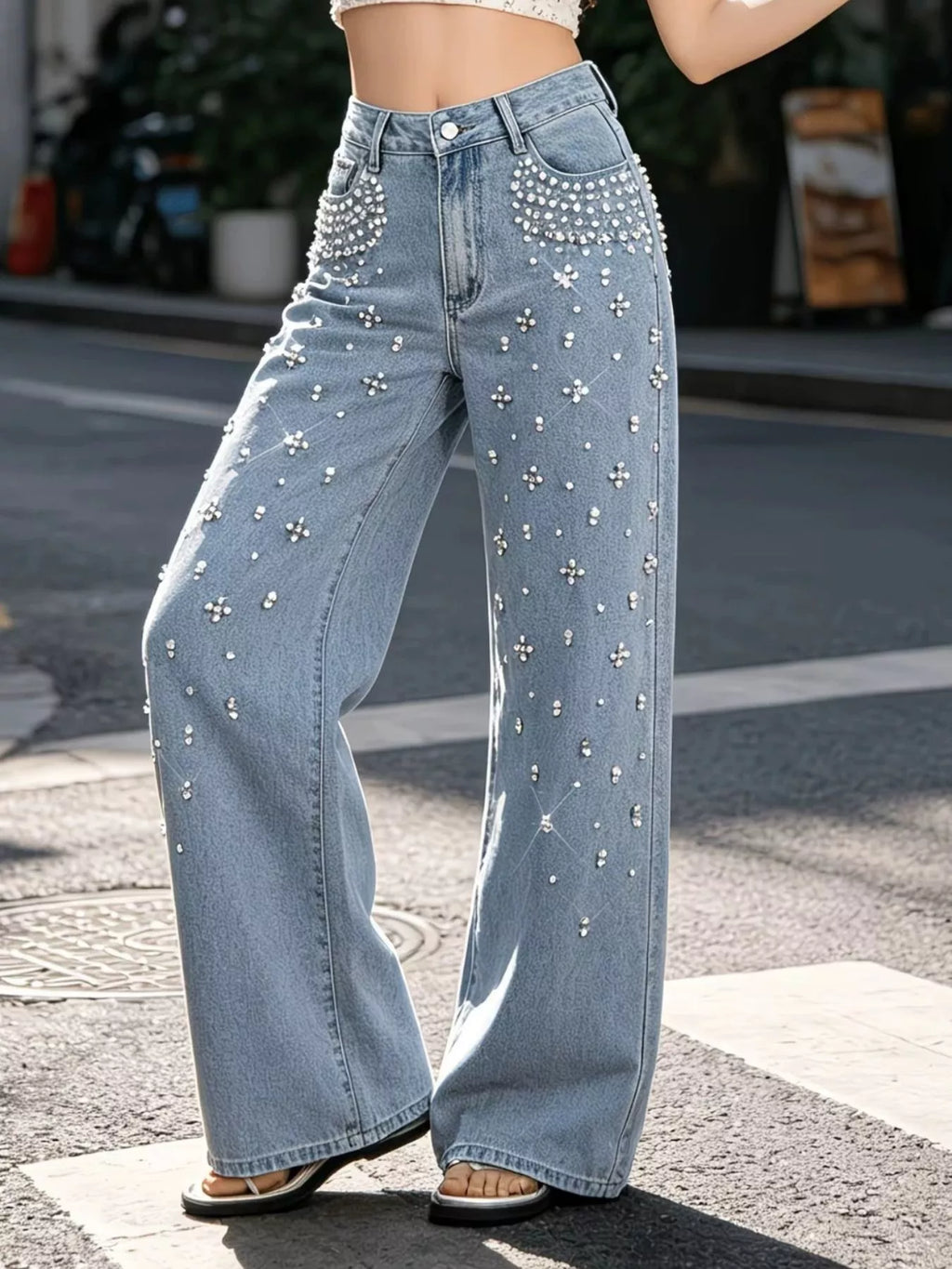 Woman wearing rhinestone embellished wide leg jeans