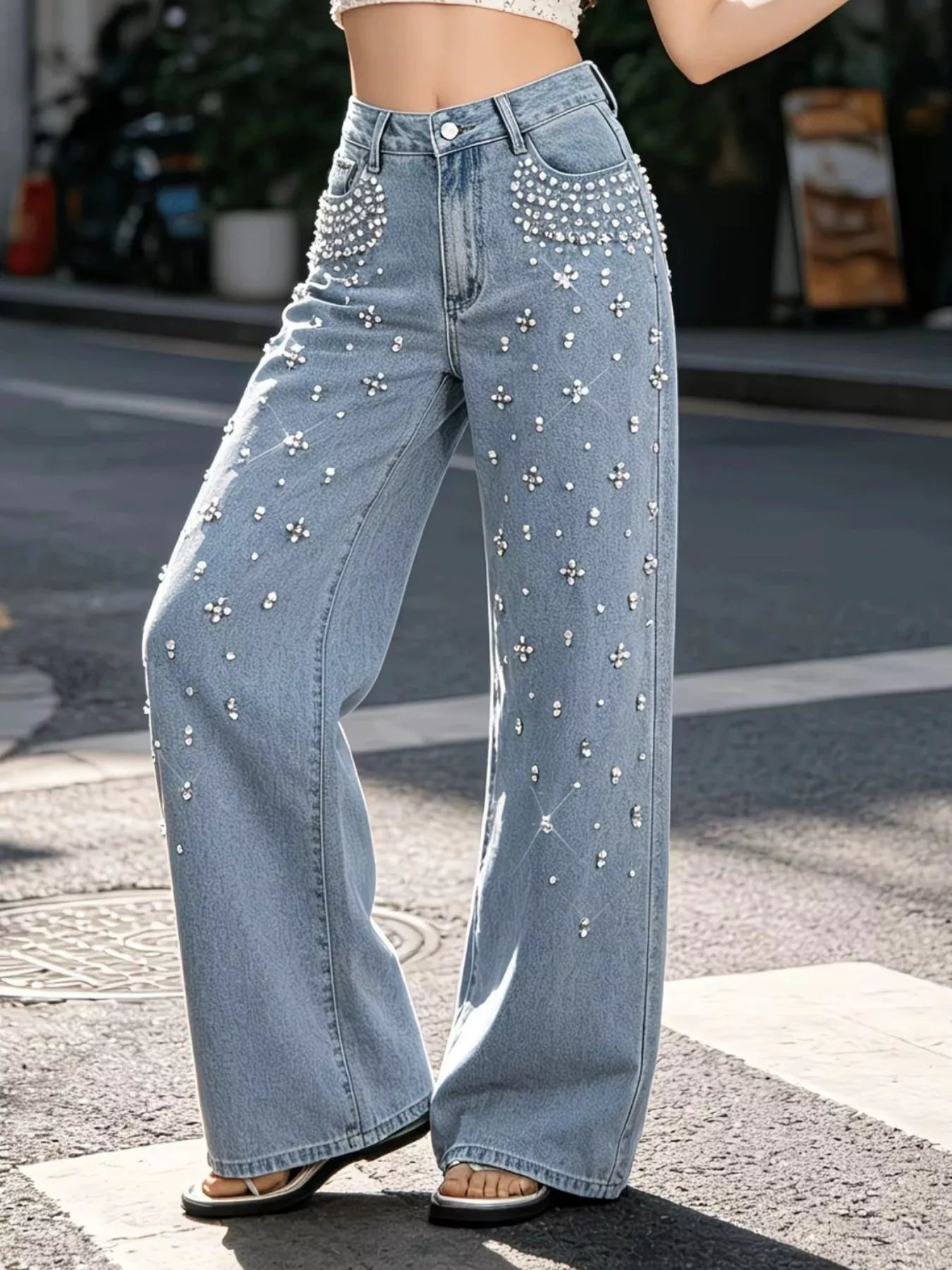 Woman wearing rhinestone embellished wide leg jeans