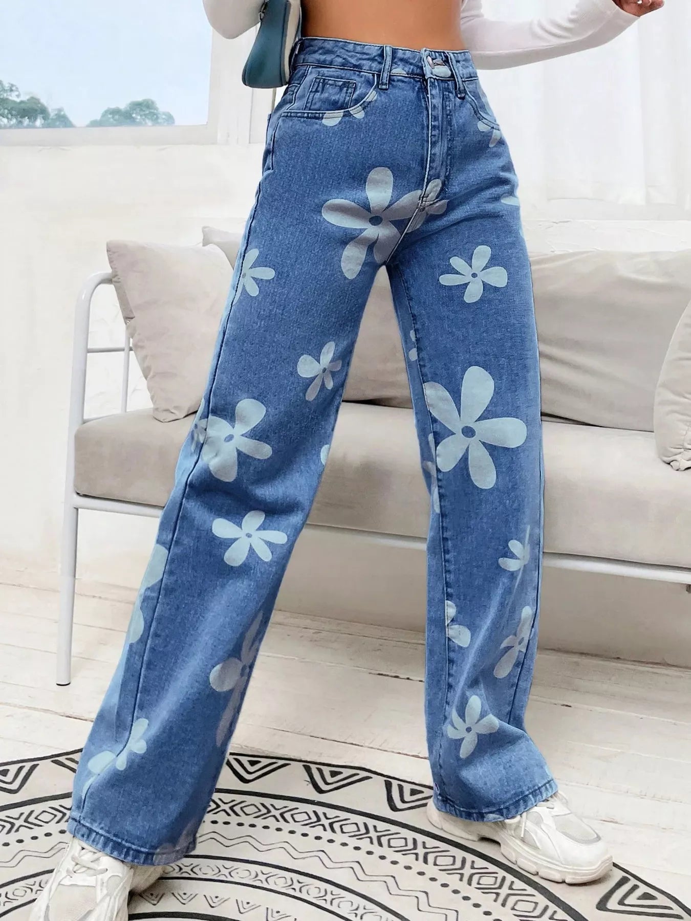 Light blue floral wide leg denim jeans front view on model