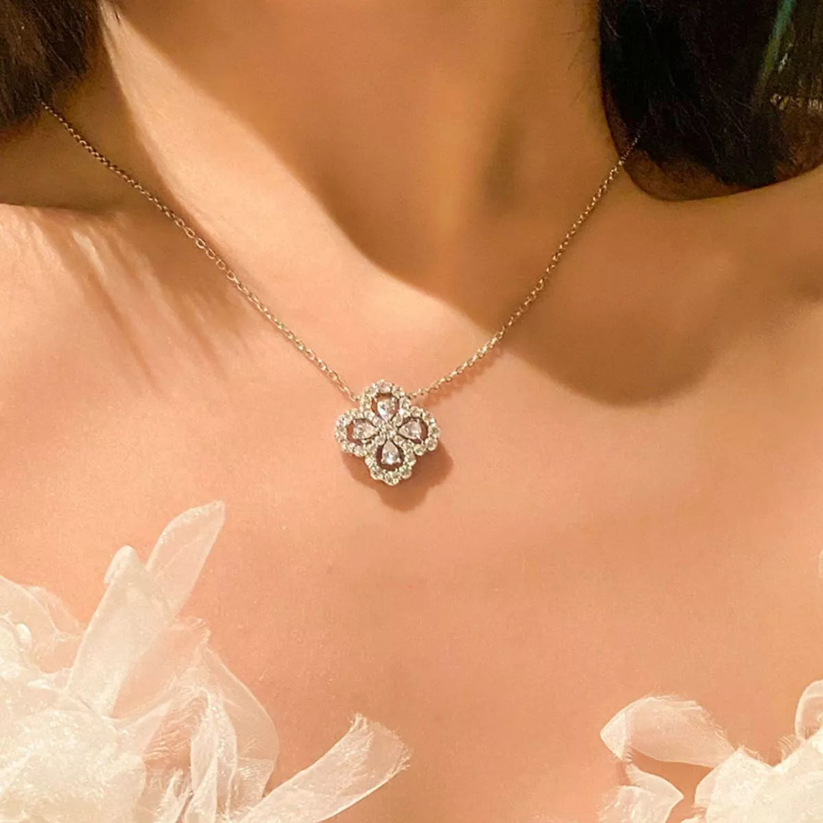 Silver clover pendant necklace on model