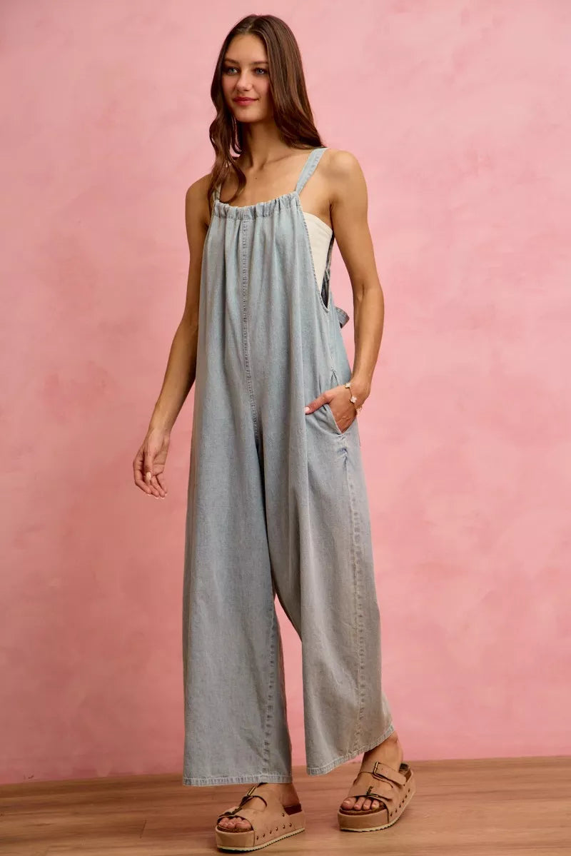 Model posing in wide leg denim overalls outdoors