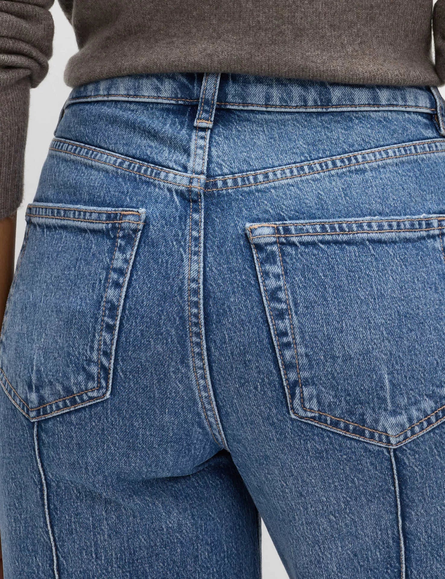 Front seam detail on blue wide leg jeans