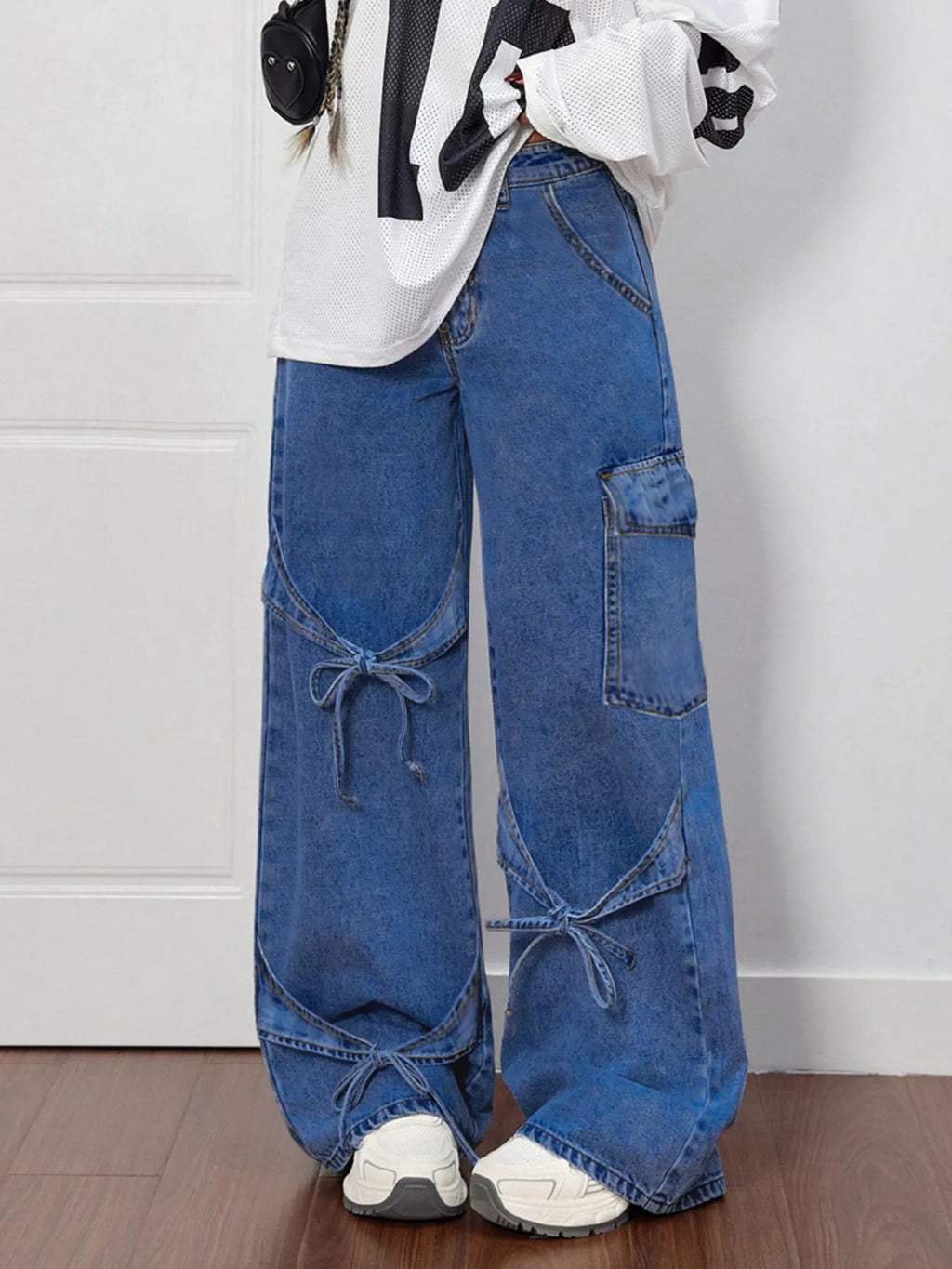 Bow tie accent detail on dark blue jeans