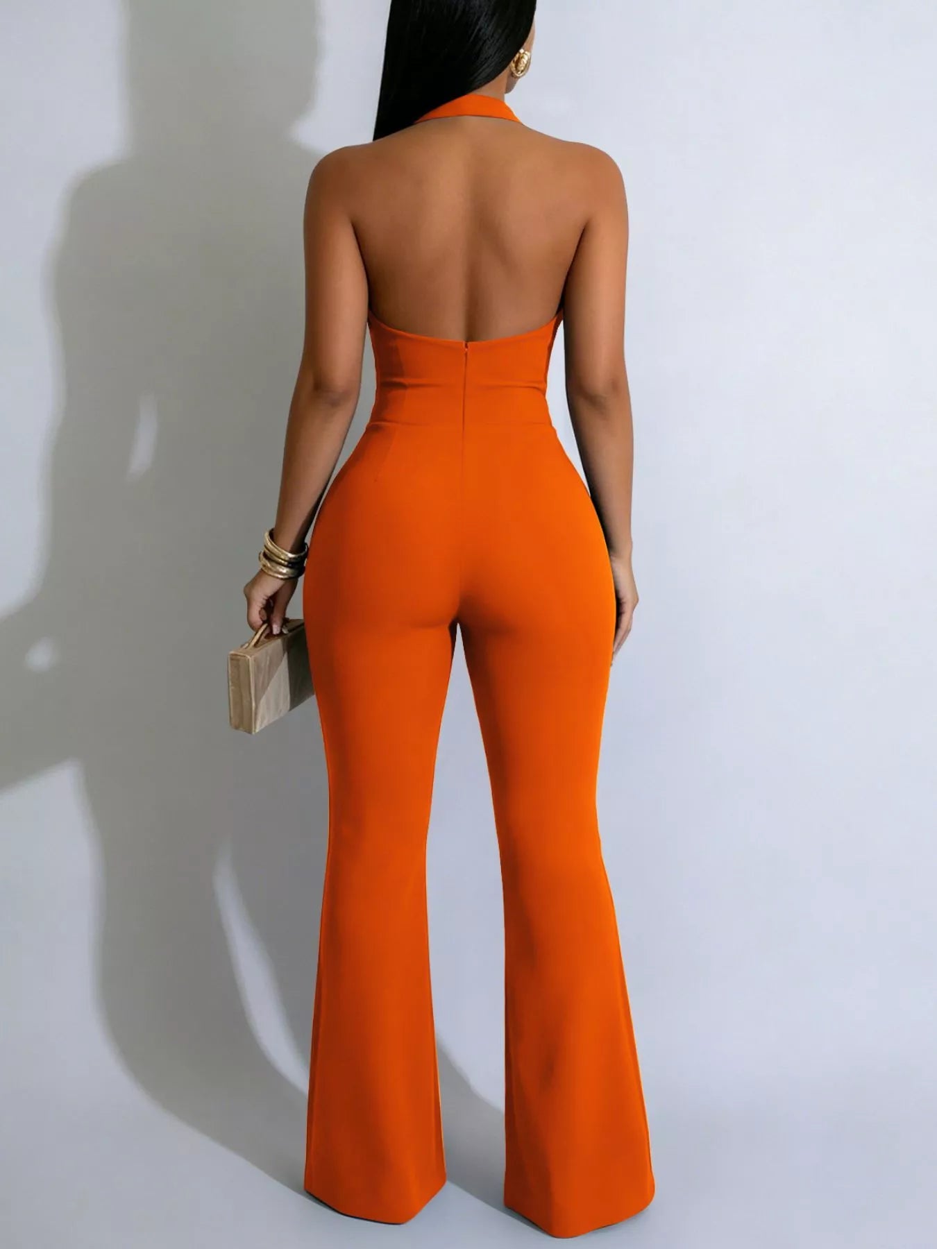 Orange flare jumpsuit side view on model