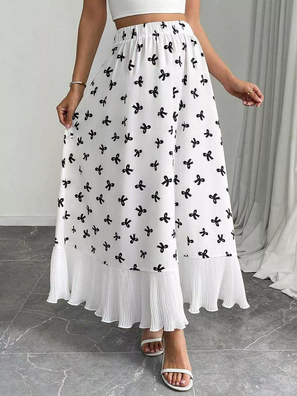 Model wearing flowy bow print maxi skirt