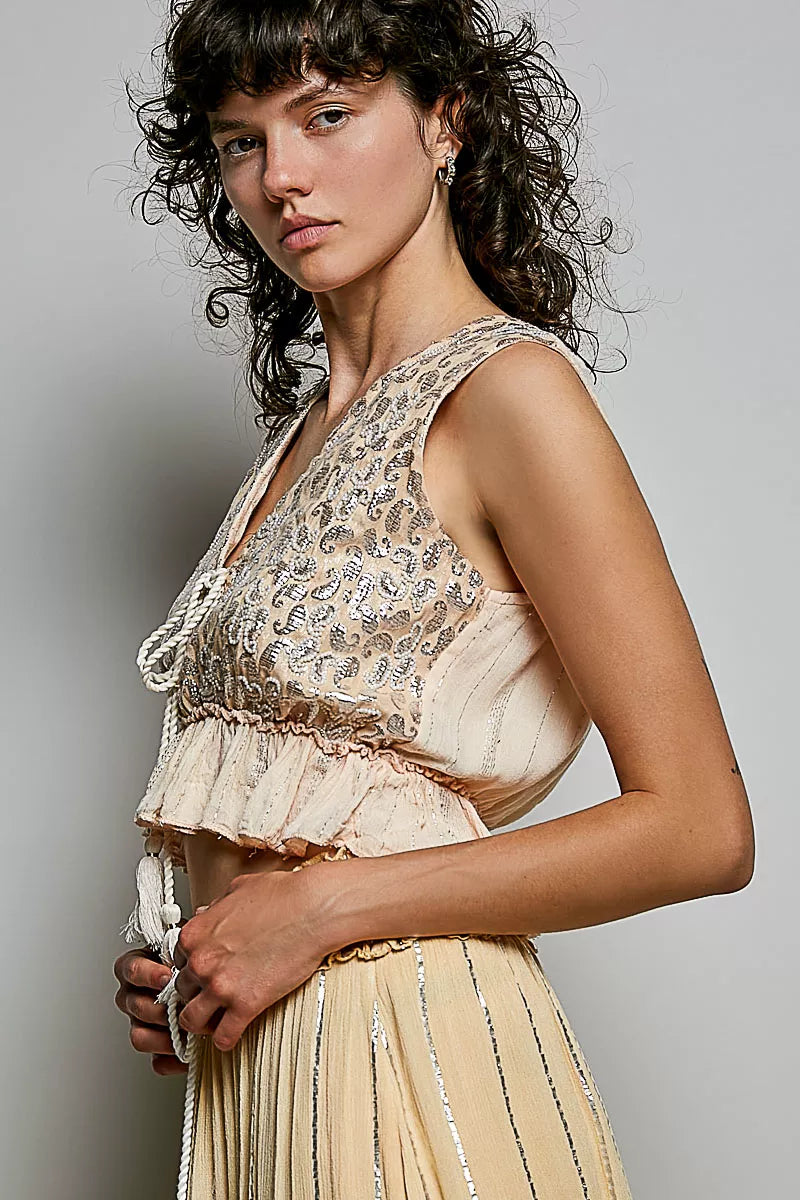 Deep V sleeveless shimmer crop top on model