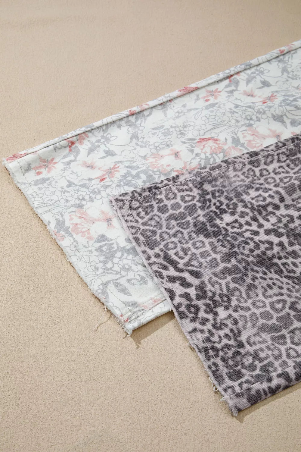 Leopard and floral print jeans flat lay