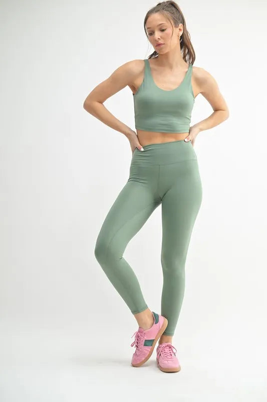 Model wearing Venice Cloud high waisted yoga leggings in moss