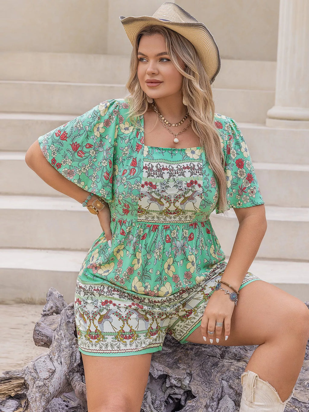Plus size floral romper styled full length on model