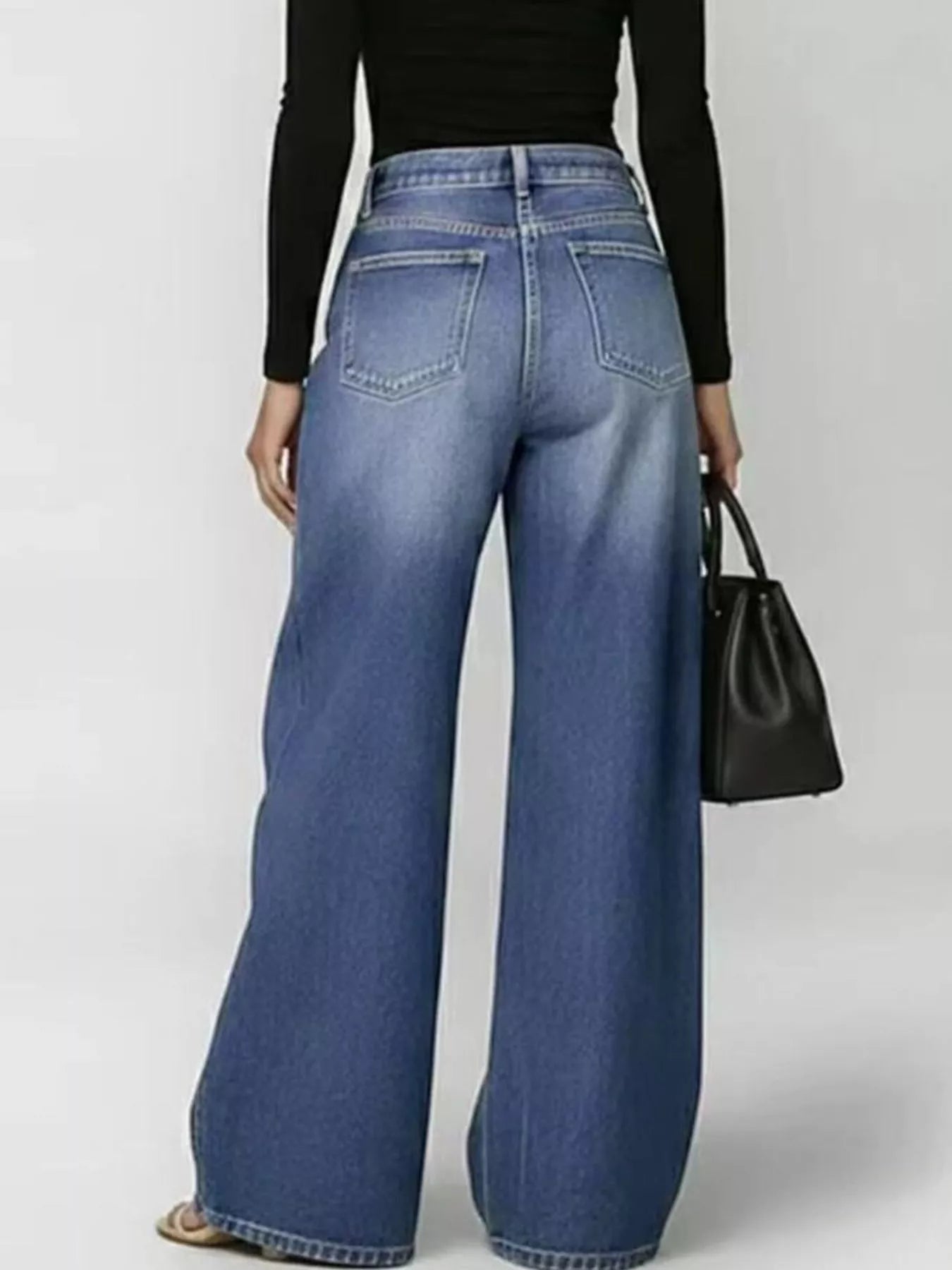Woman wearing eyelet detail wide leg jeans