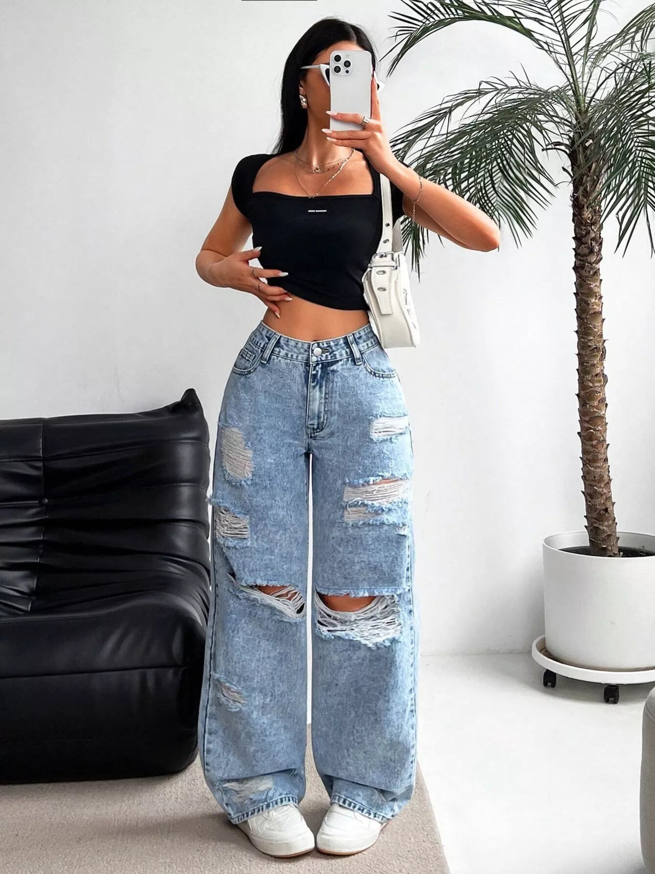 Wide leg silhouette of distressed jeans