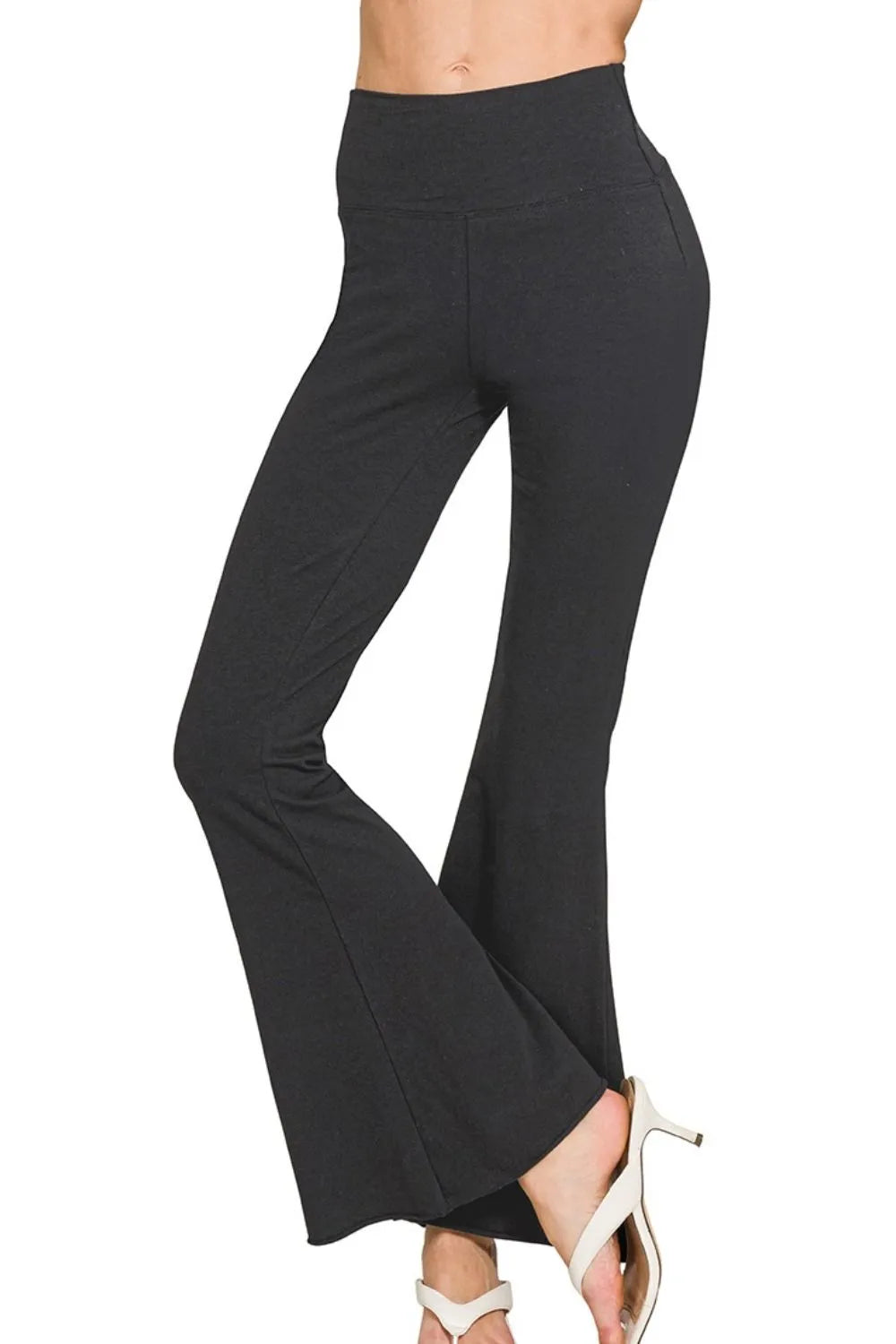 Raw edge hem detail on black flare yoga pants