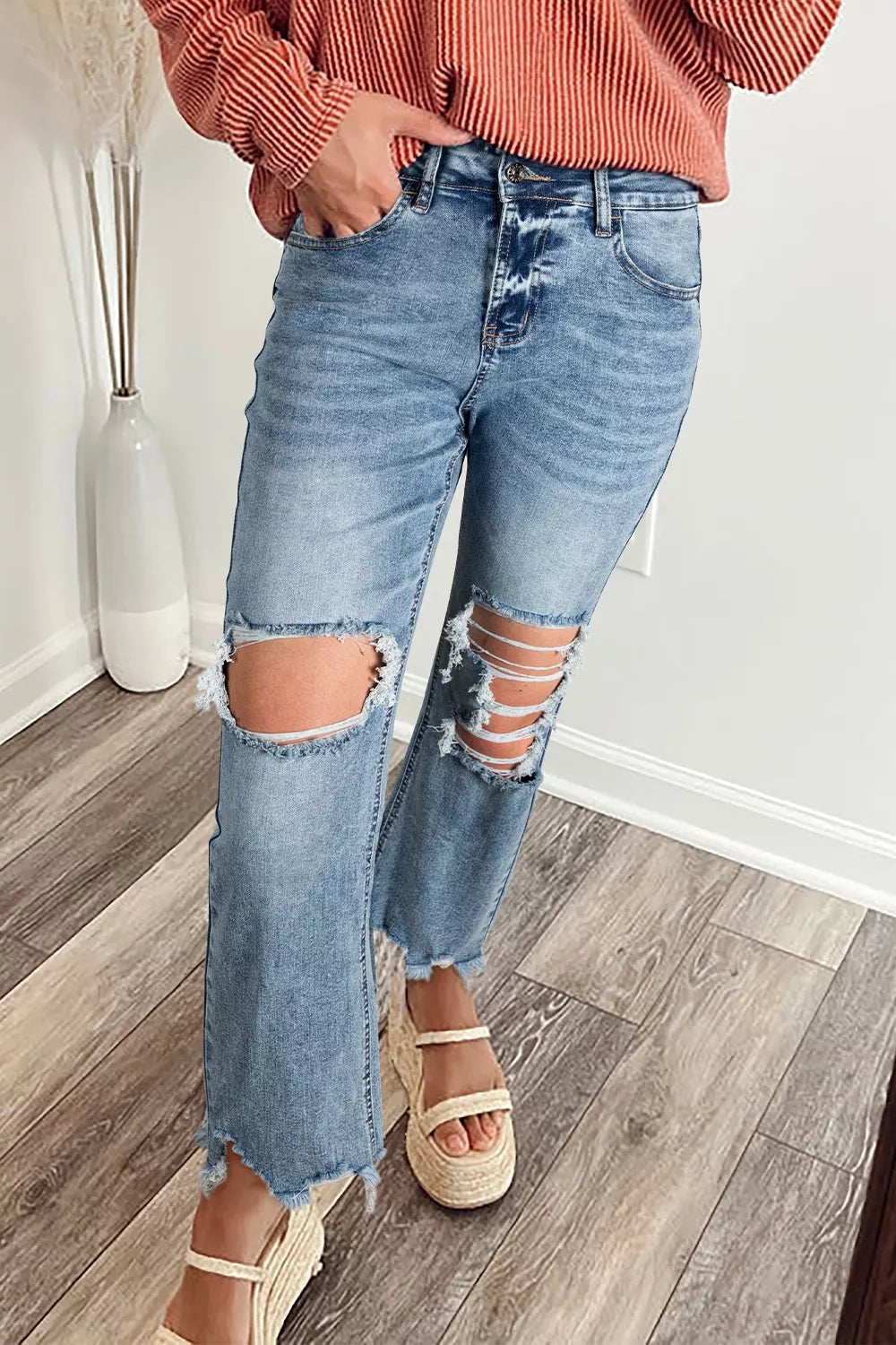 Ripped open knee flare jeans with raw hem front view