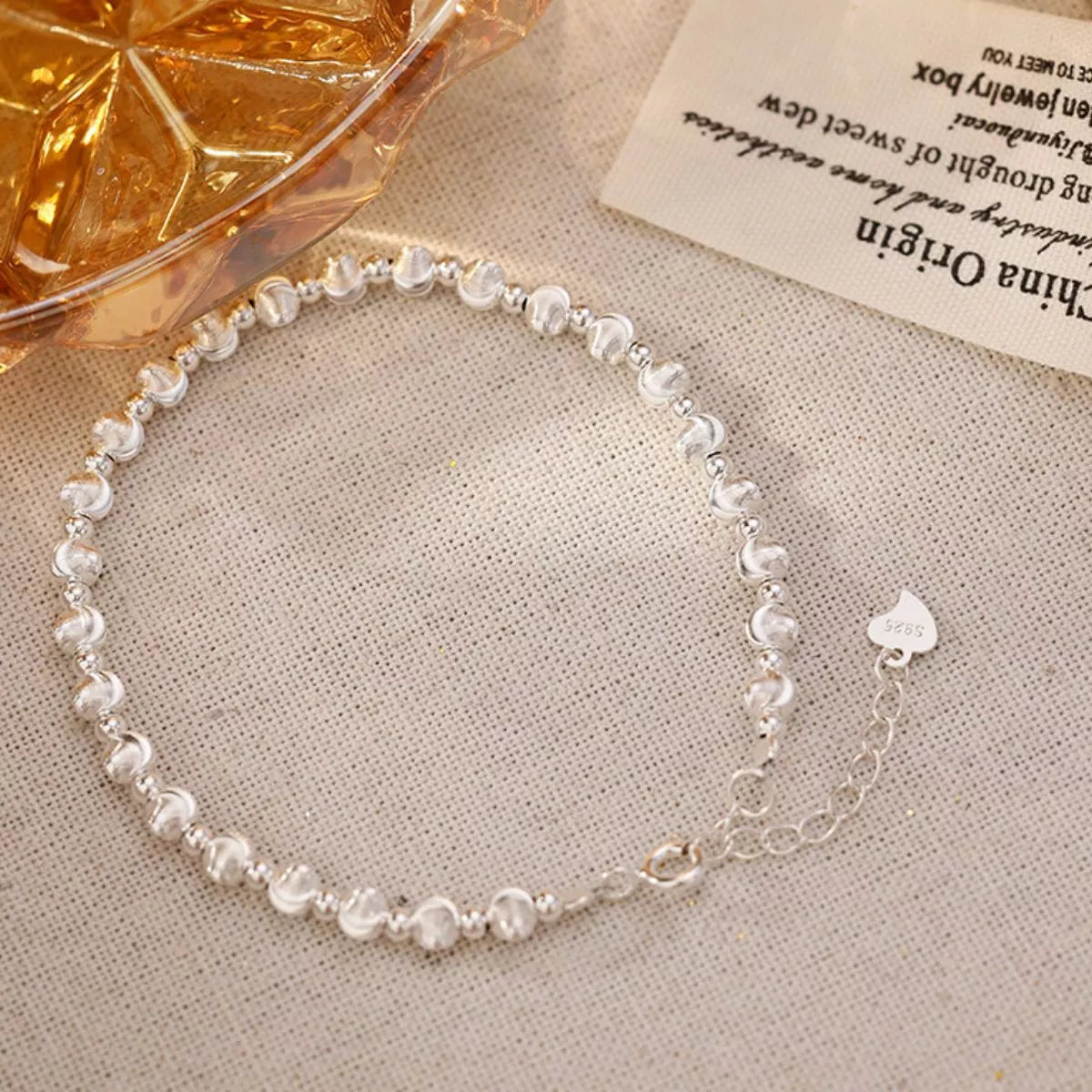 Beaded silver bracelet styled with other bangles