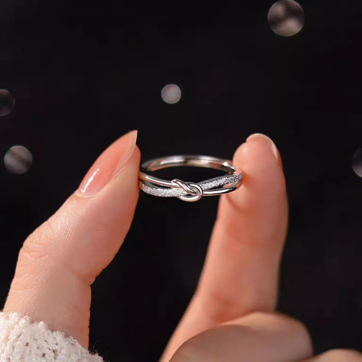 Silver love knot ring angled detail view