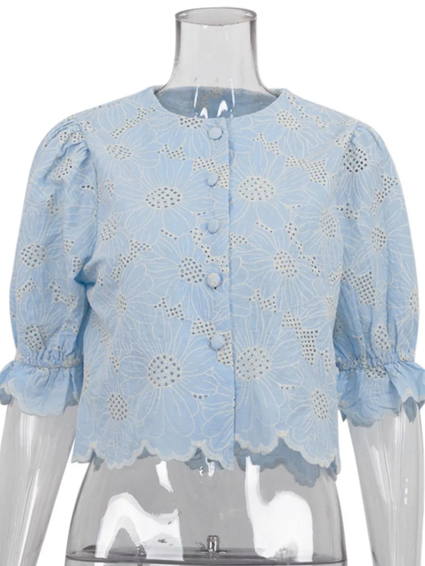 Model wearing light blue embroidered blouse