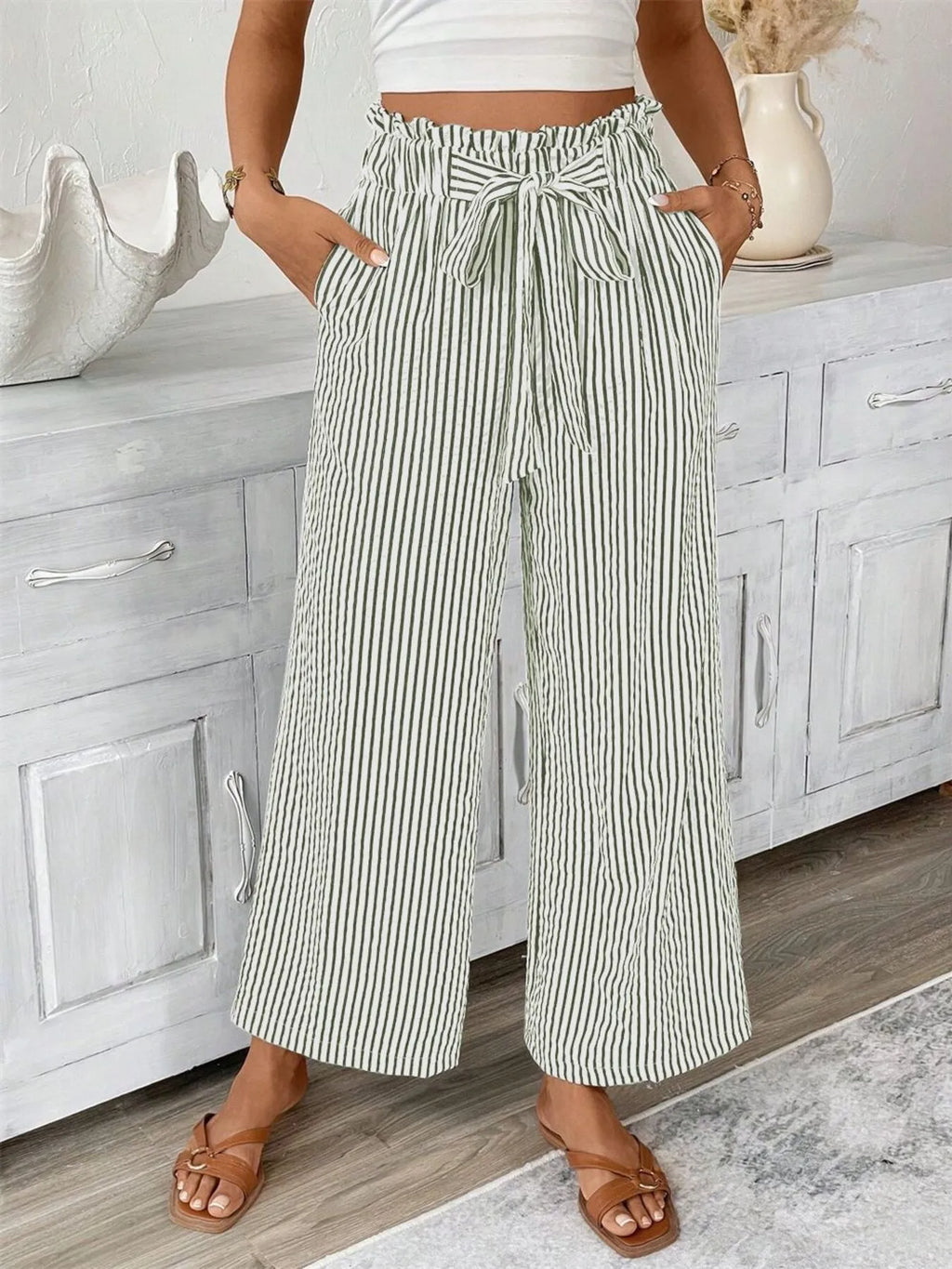 Woman wearing army green wide leg paper bag pants front view