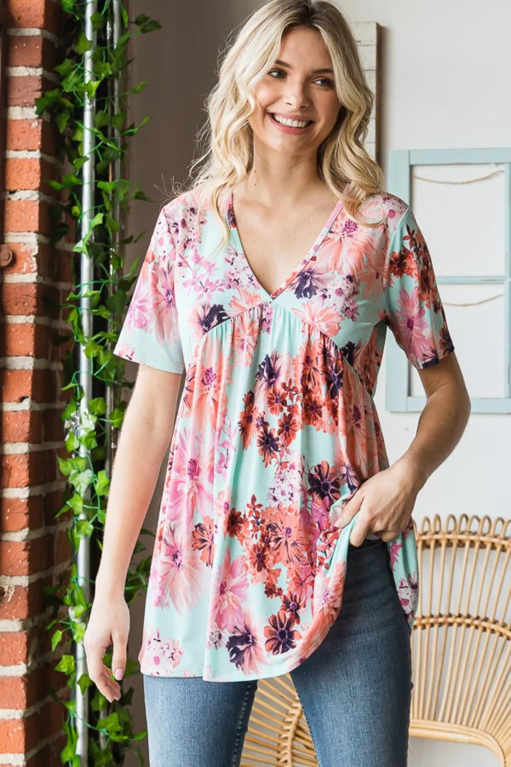 Close up of floral print on mint babydoll blouse