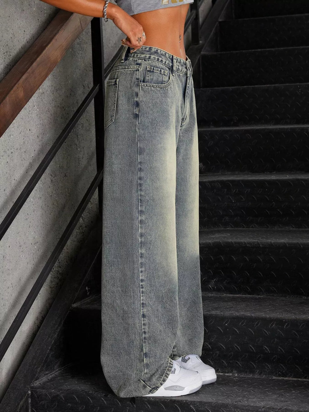 Fluid drape detail on vintage wash jeans