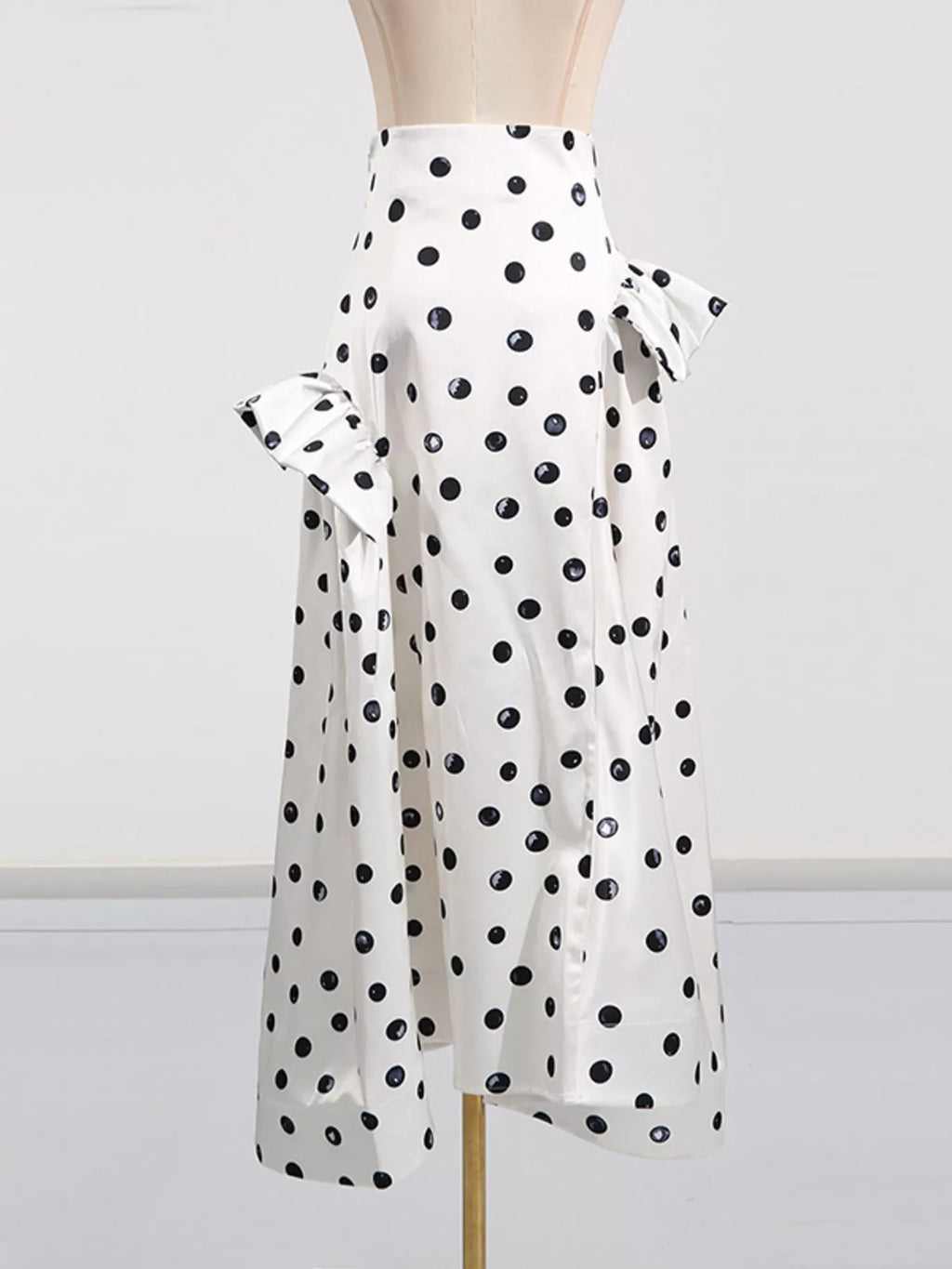 Beige polka dot midi skirt styled on model