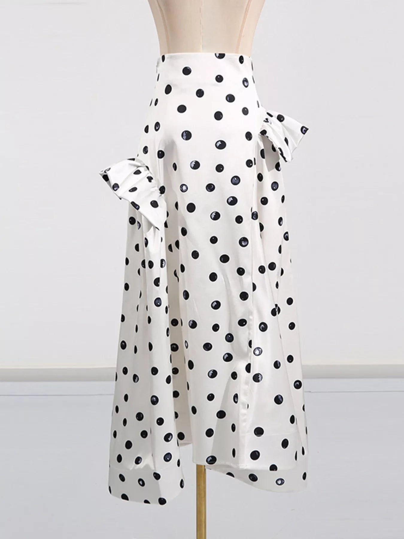 Beige polka dot midi skirt styled on model
