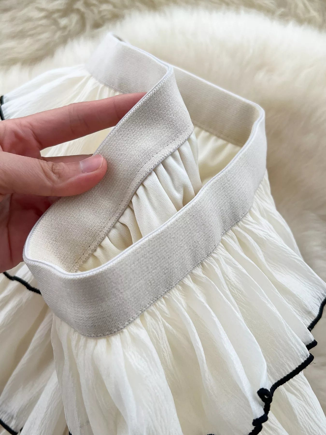 Close up of tiered ruffles on apricot skirt