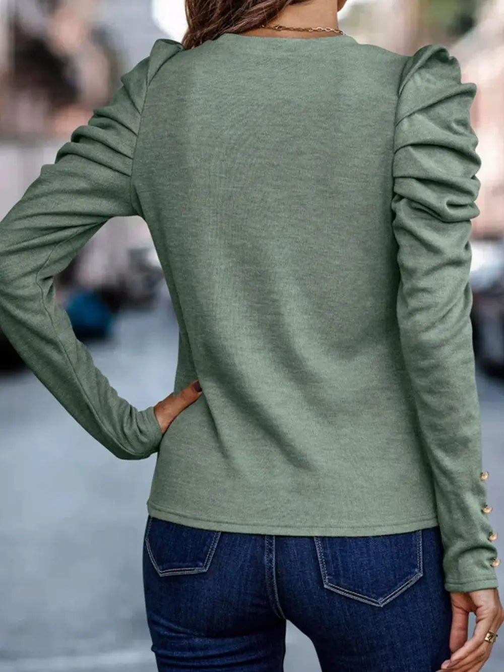 Sage round neck blouse styled on model