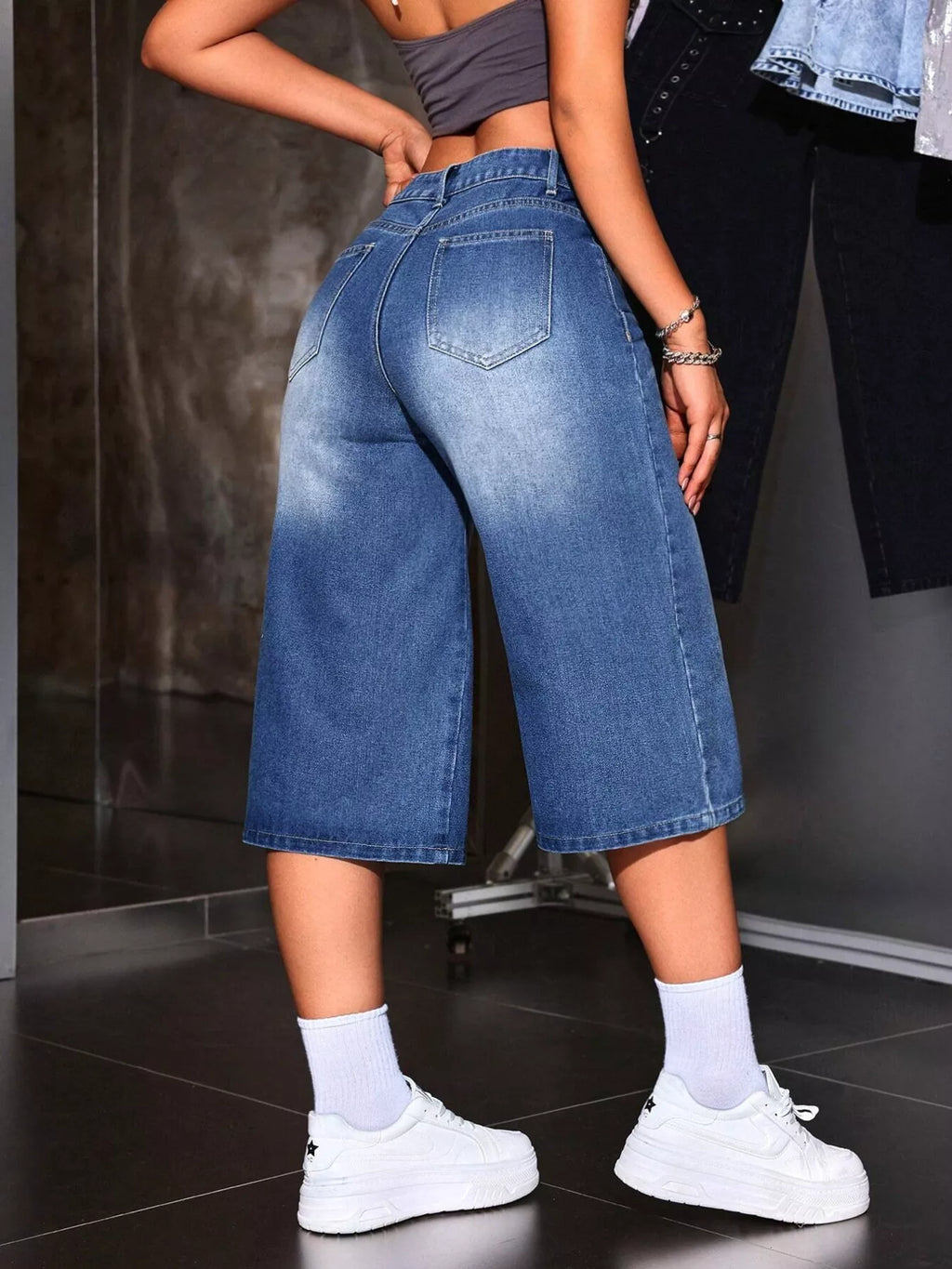 Close up of pocket and waistband detail on blue denim capris