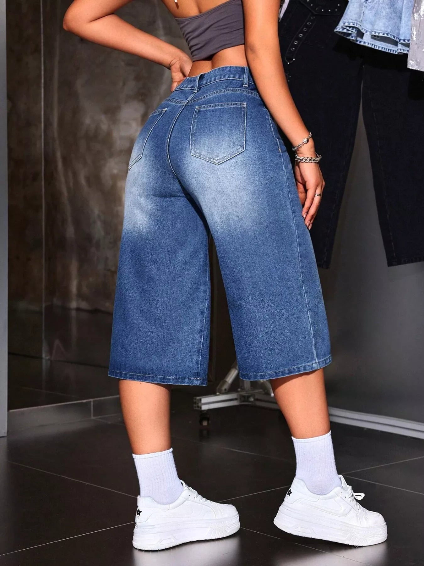 Close up of pocket and waistband detail on blue denim capris