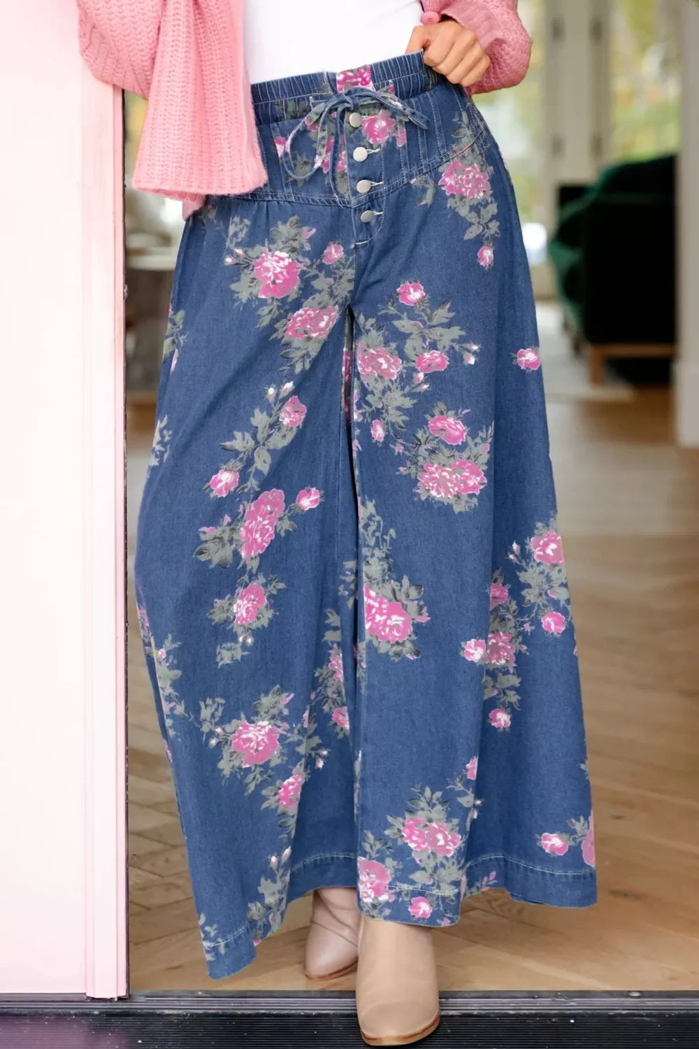 Woman wearing floral print wide leg jeans