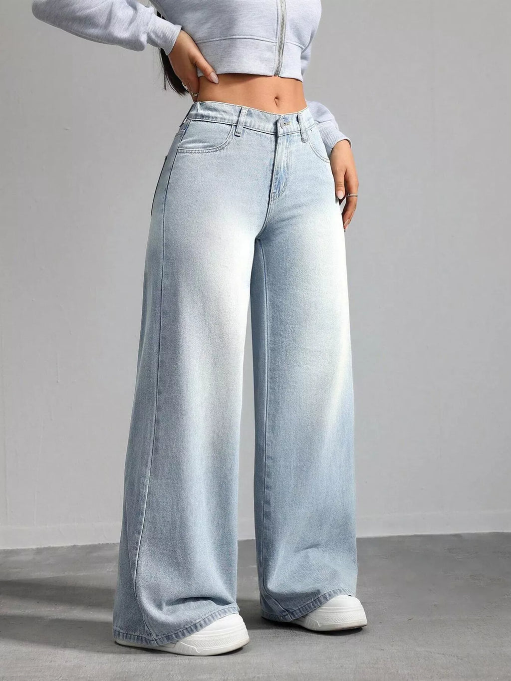 Woman wearing high waisted light blue wide leg jeans