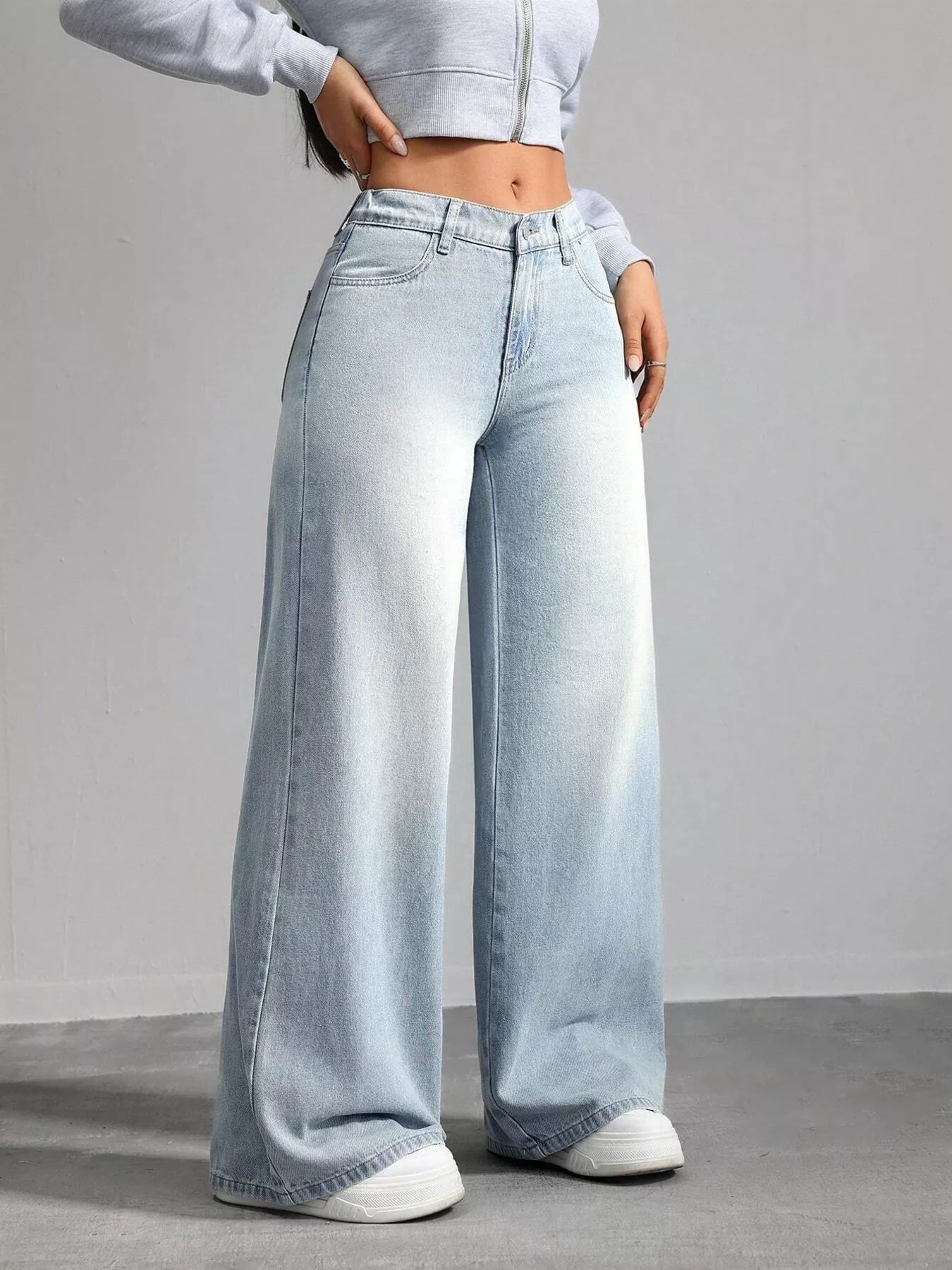 Woman wearing high waisted light blue wide leg jeans