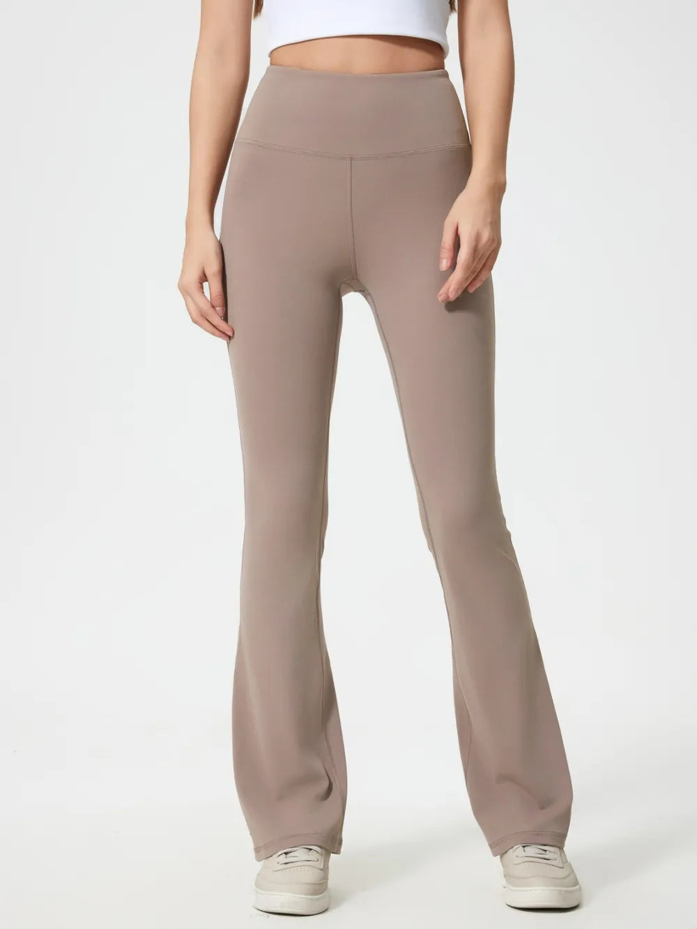 Woman wearing dark gray high waist active pants front view
