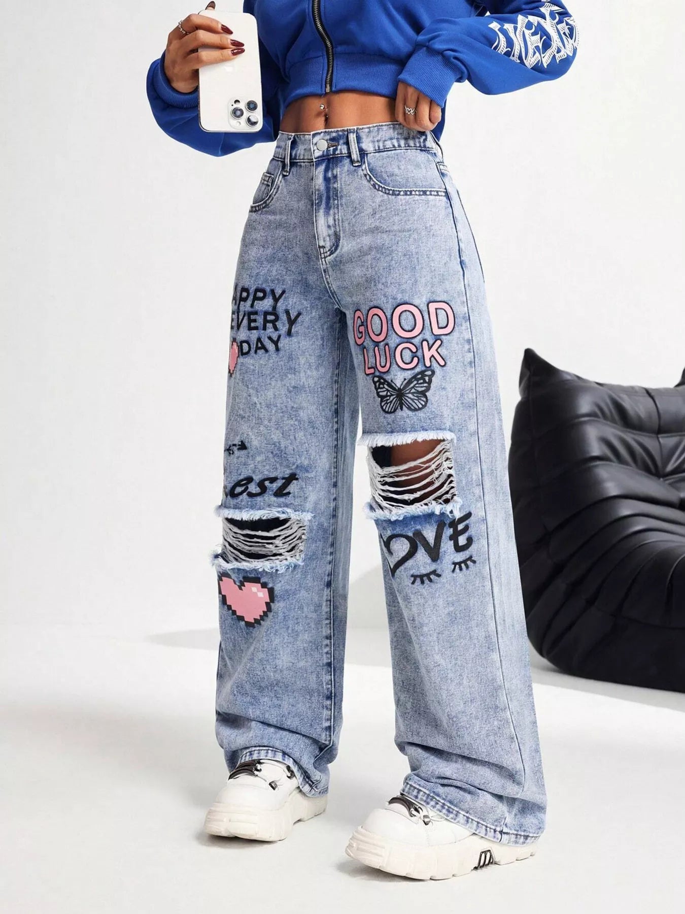 Ripped distressed detail on graffiti jeans