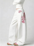 Embroidered wide leg jeans in white front view