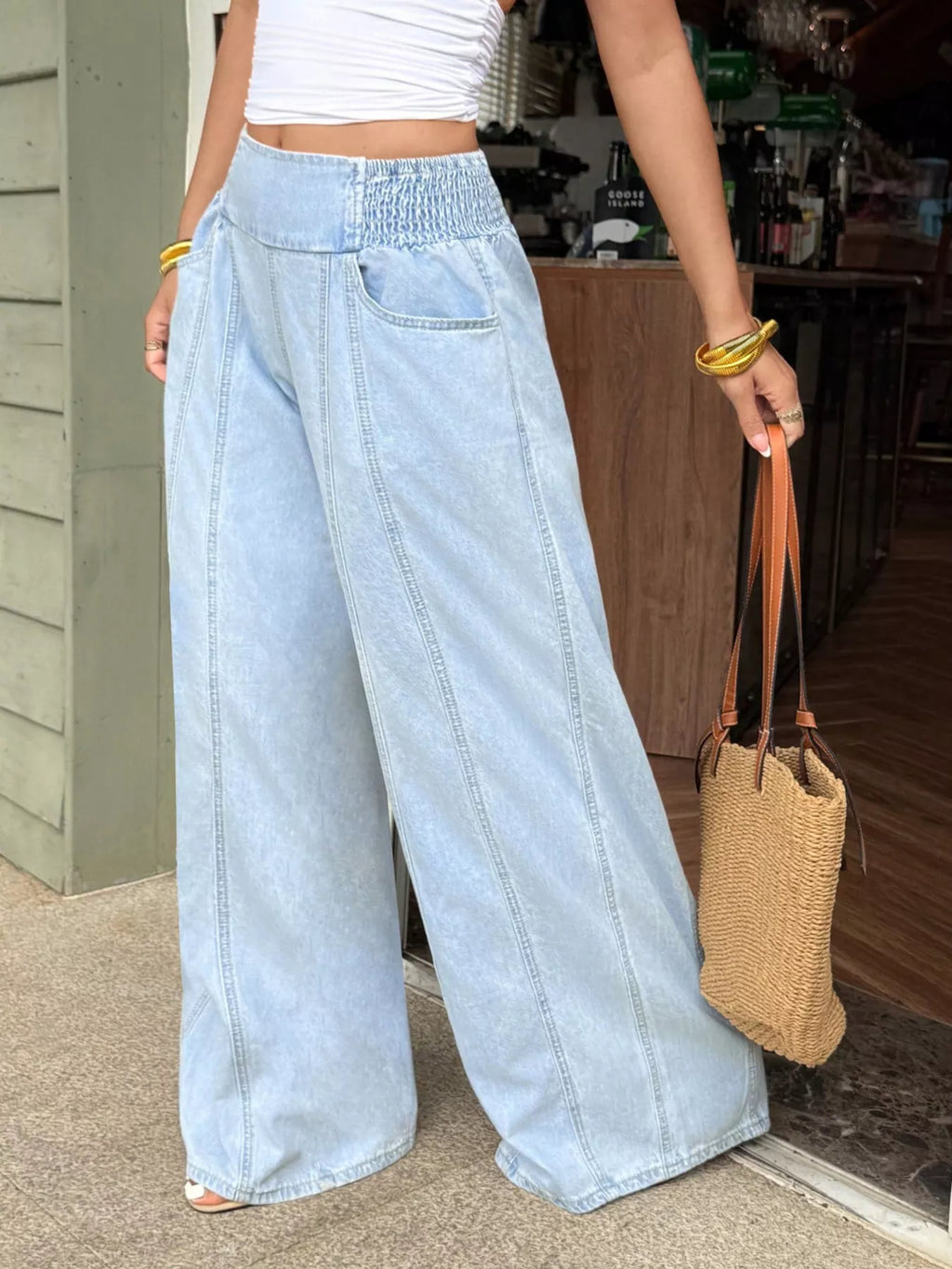 Pocket and seam detail on washed wide leg jeans