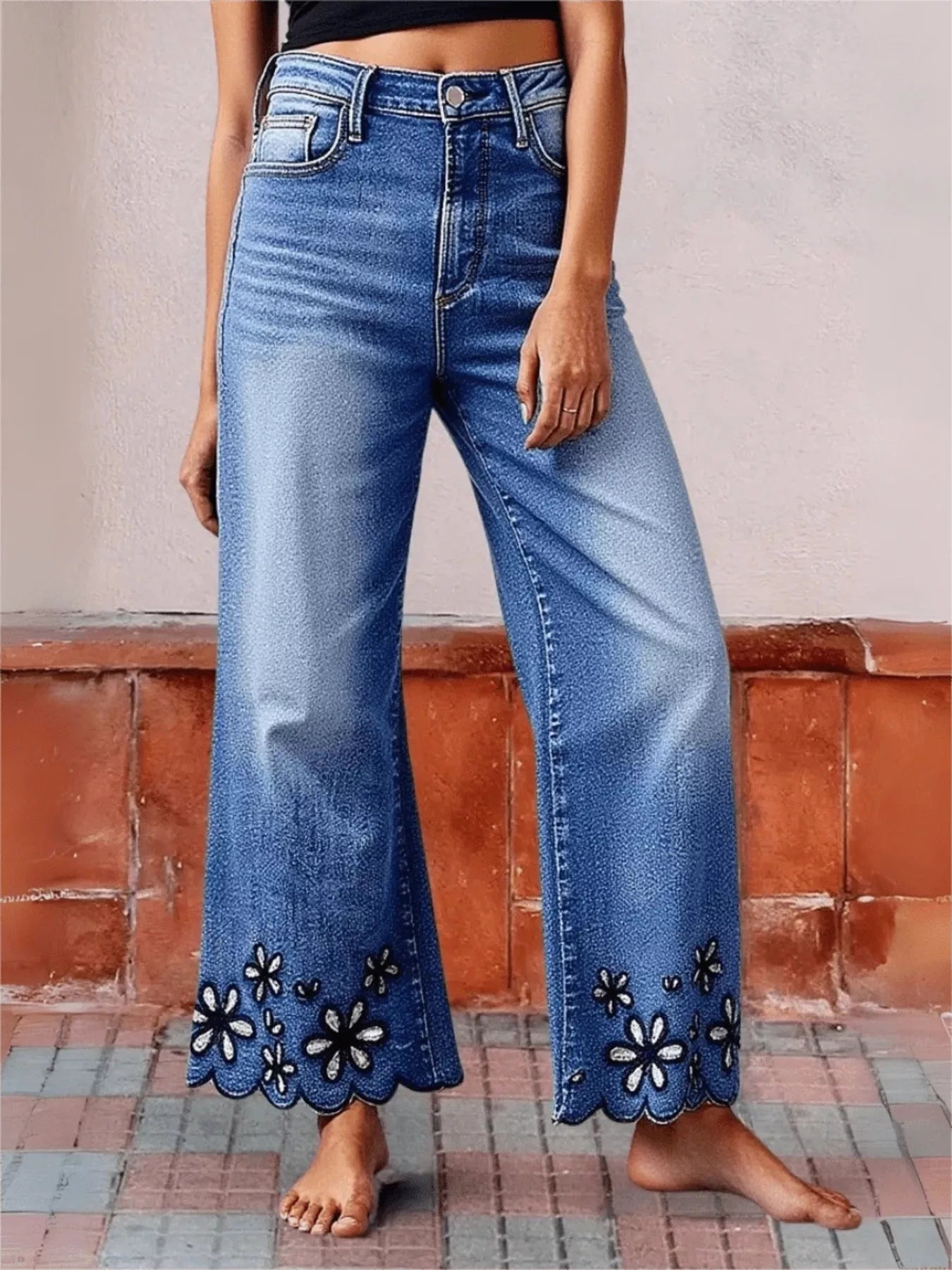 Side view of blue embroidered wide leg cropped jeans