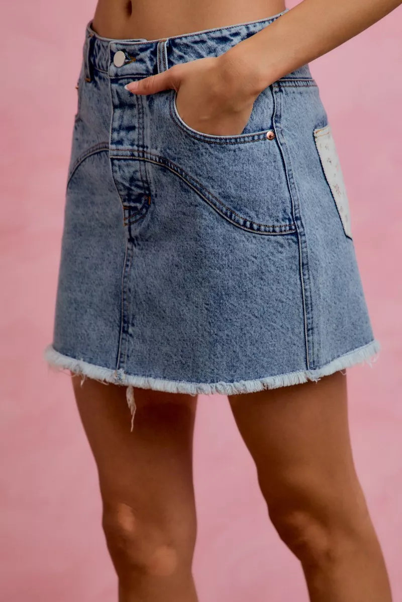 Denim floral mini skirt back view showing contrast pockets