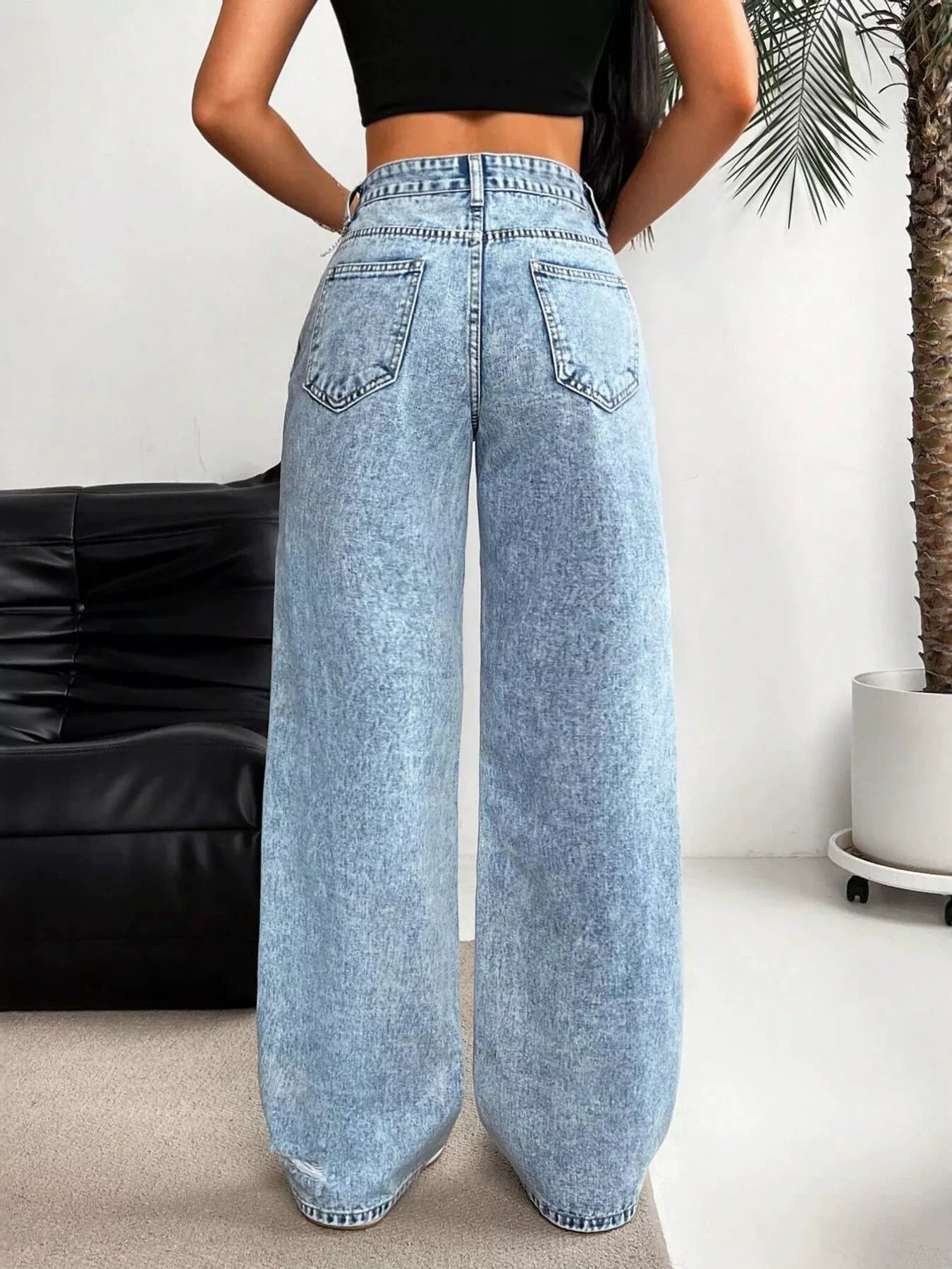 Raw hem detail on light wash jeans