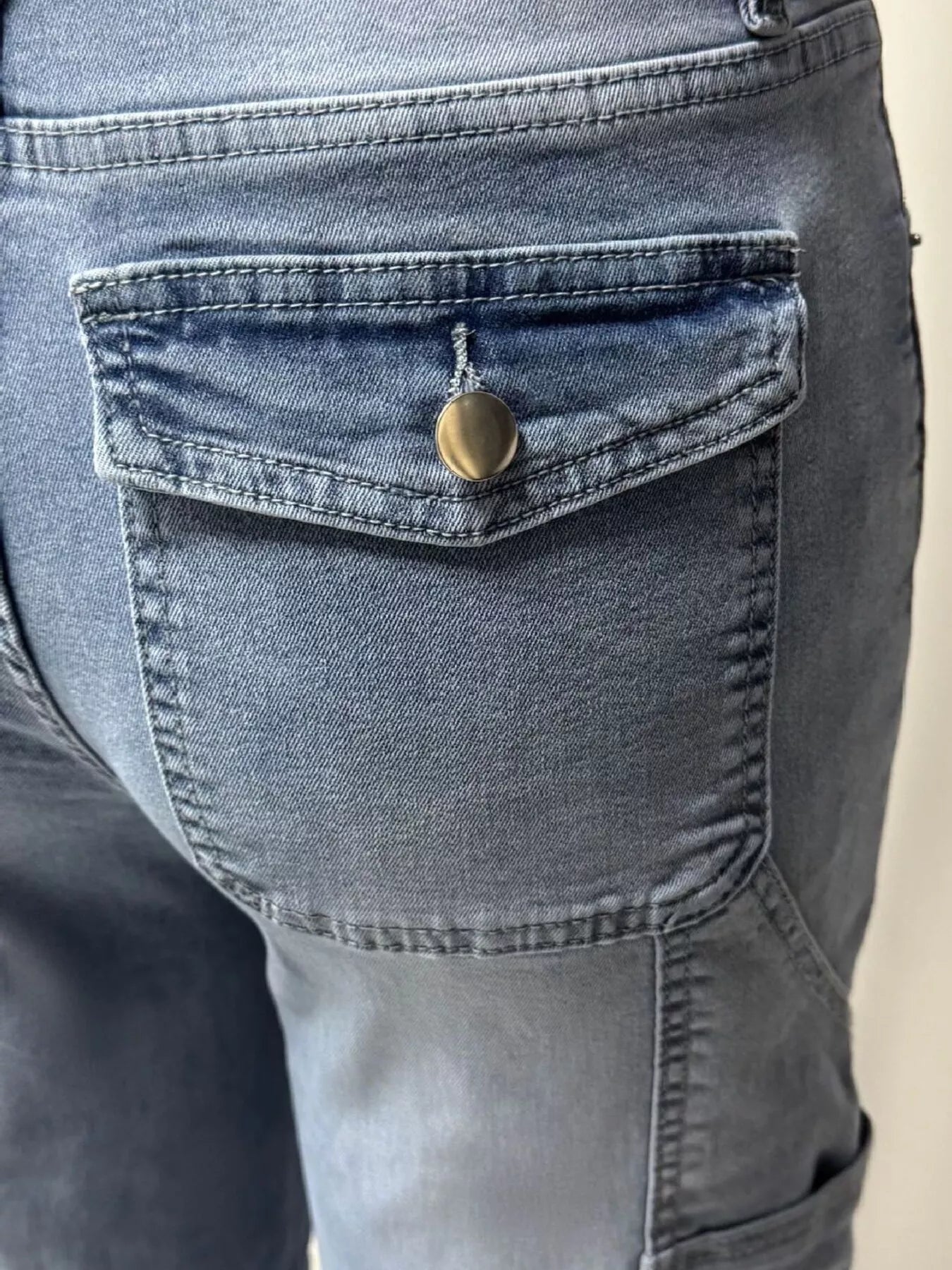 Washed denim fabric detail on blue wide leg jeans