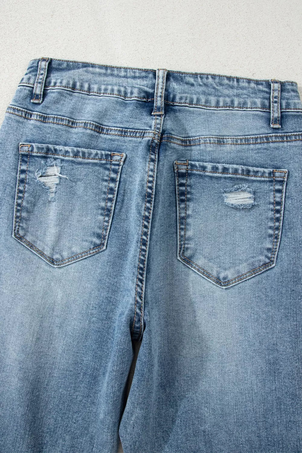 Medium wash denim distressing close up