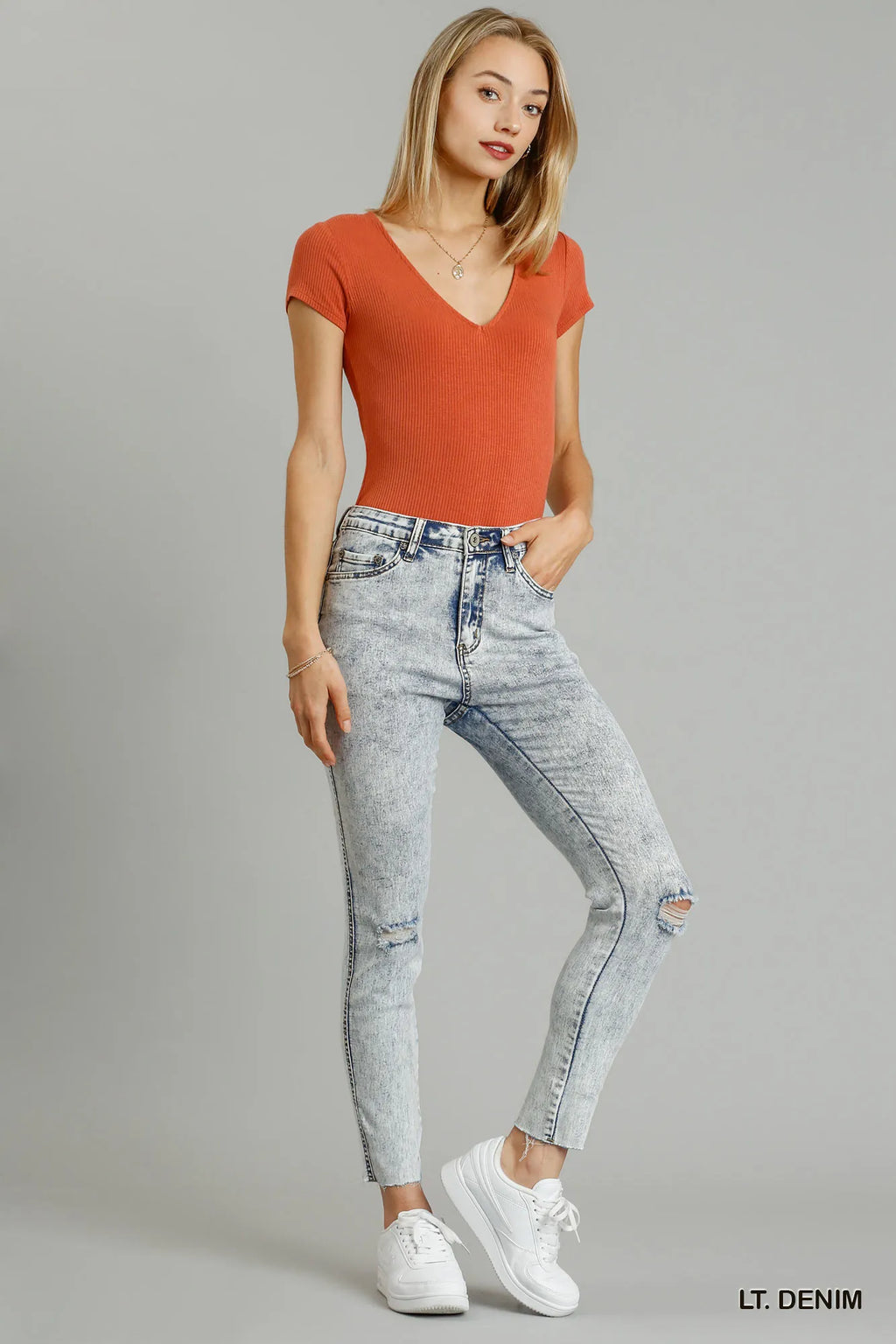 Distressed stretch denim skinny jeans light wash front view
