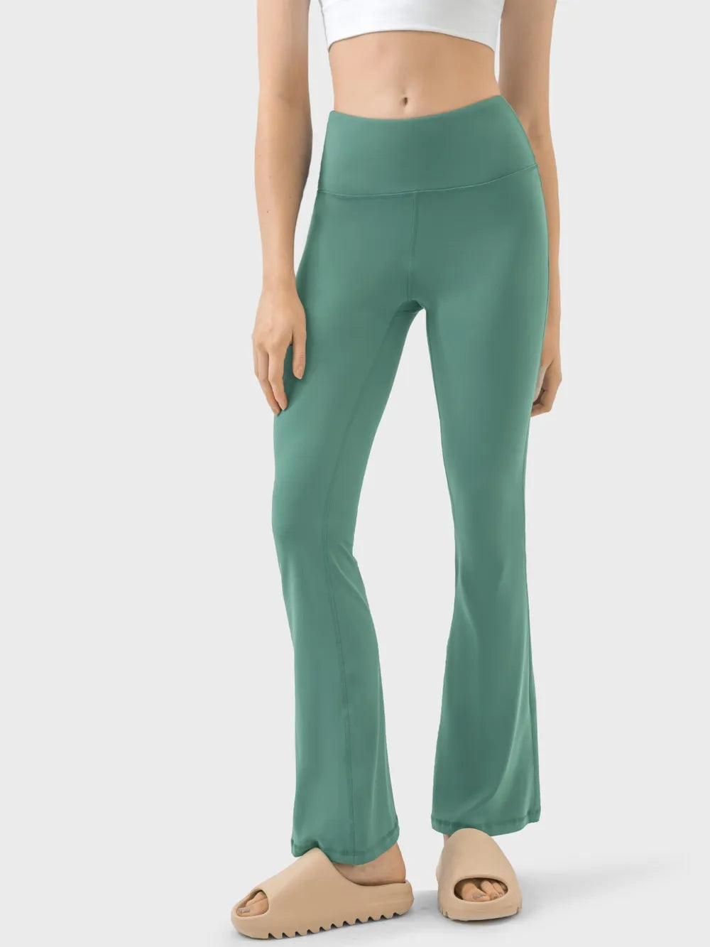 Woman wearing heliotrope purple high waist active pants front view
