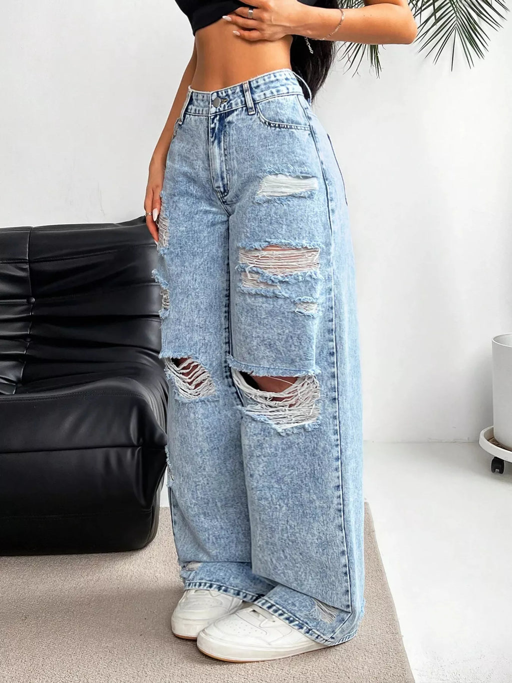 Distressed detail on light wash denim
