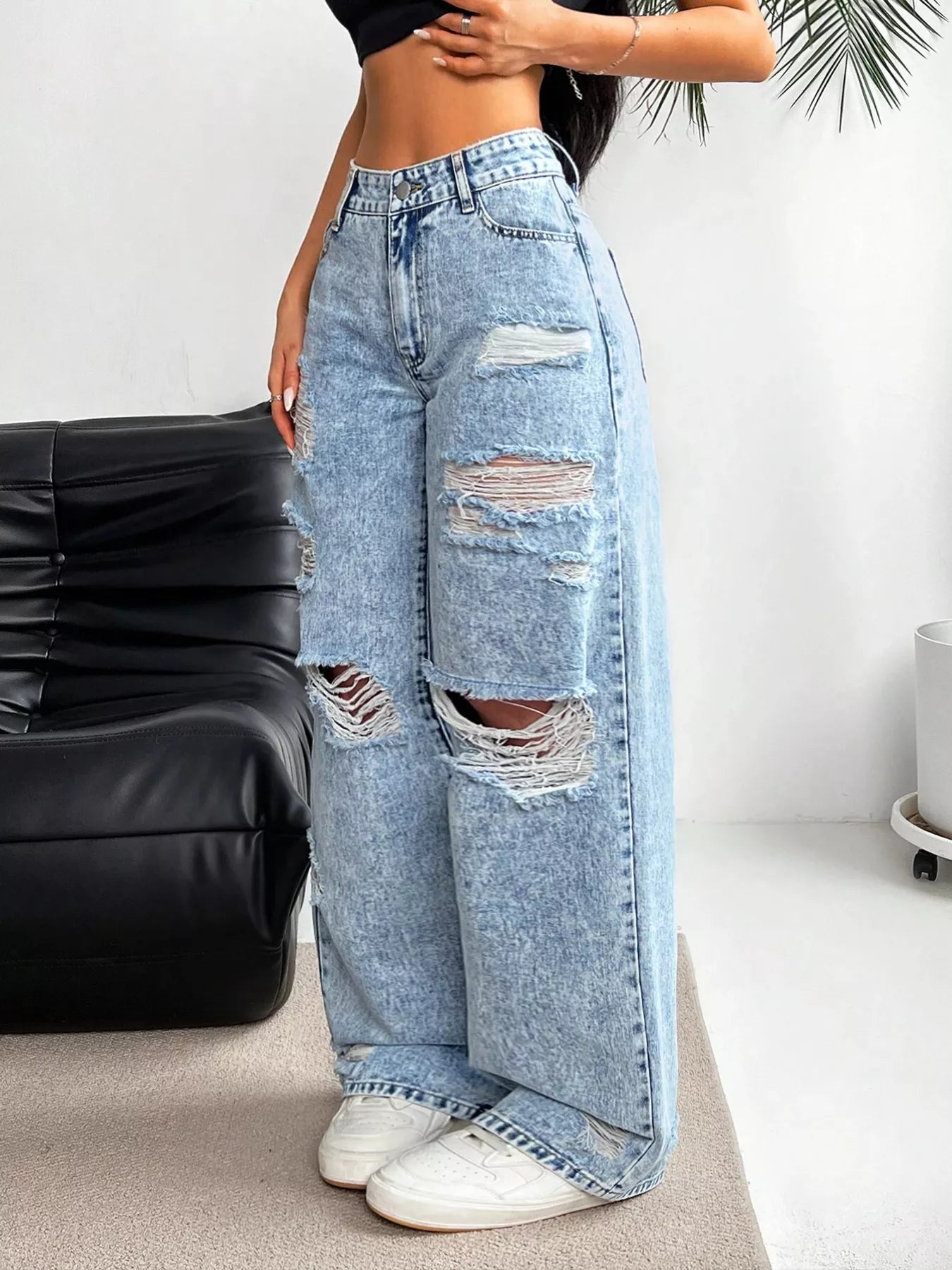 Distressed detail on light wash denim