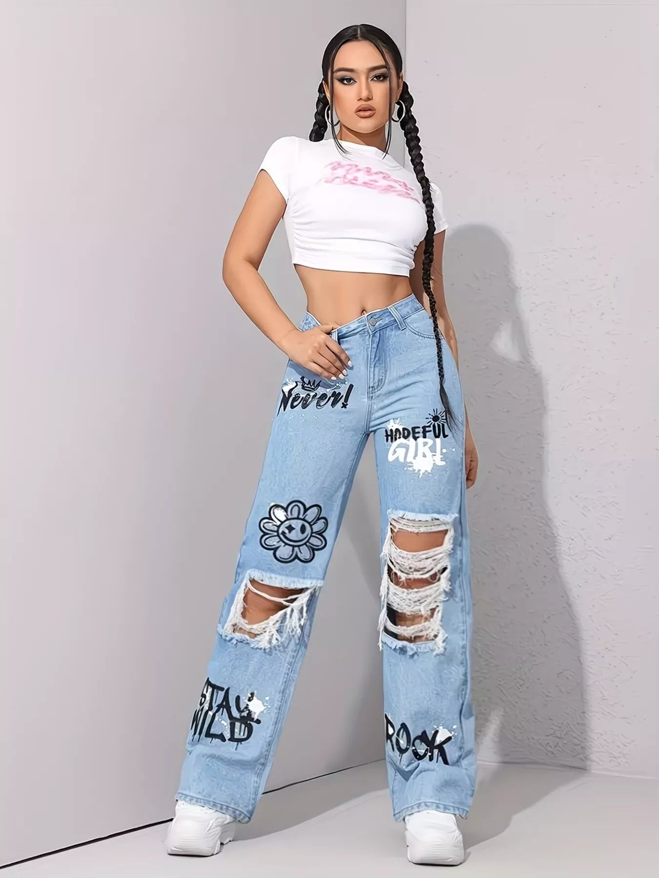 Raw hem detail on graffiti distressed jeans