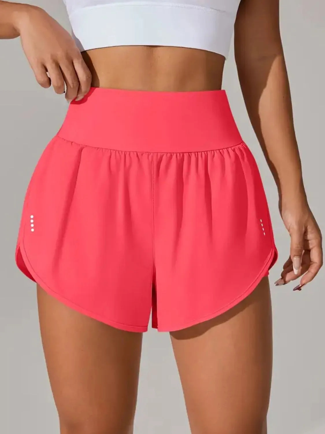Neon green high waist gym shorts side view on model
