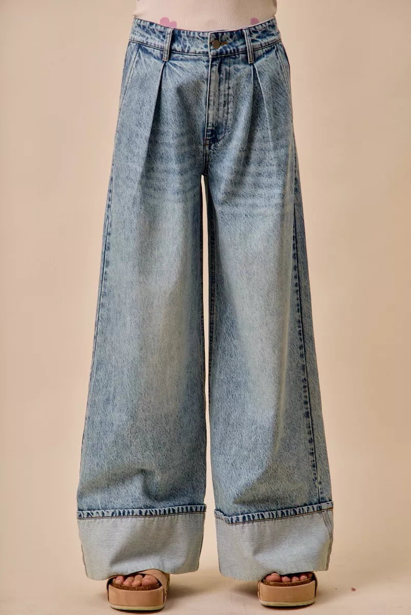Mid rise pleated wide leg denim jeans front view on model